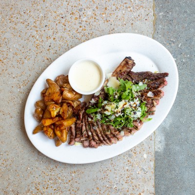 Oval white plate with meat dish from Katie's Pizza & Pasta Osteria.